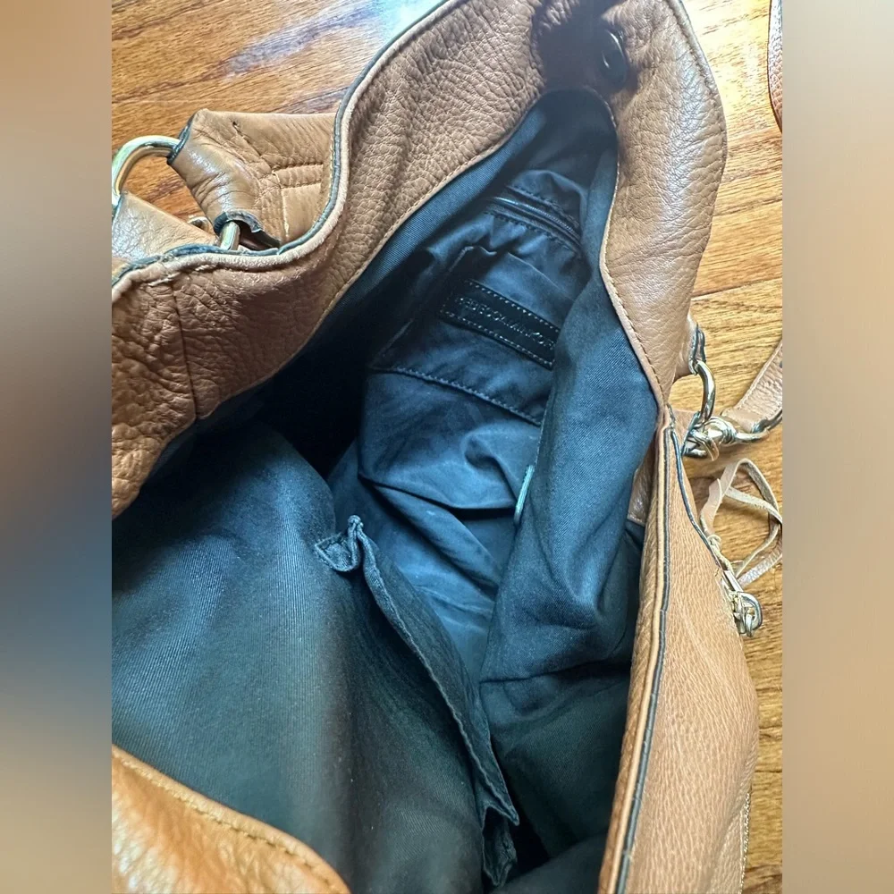 Rebecca Minkoff Moto hobo bag featuring prominent vertical zippers on the front.